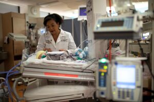 Cynthia Rogers, MD, visits a premature baby in the Newborn Intensive Care Unit at St. Louis Children's Hospital.